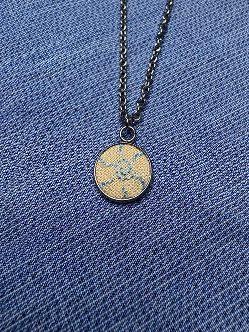 Blue spiral sun pendant necklace
